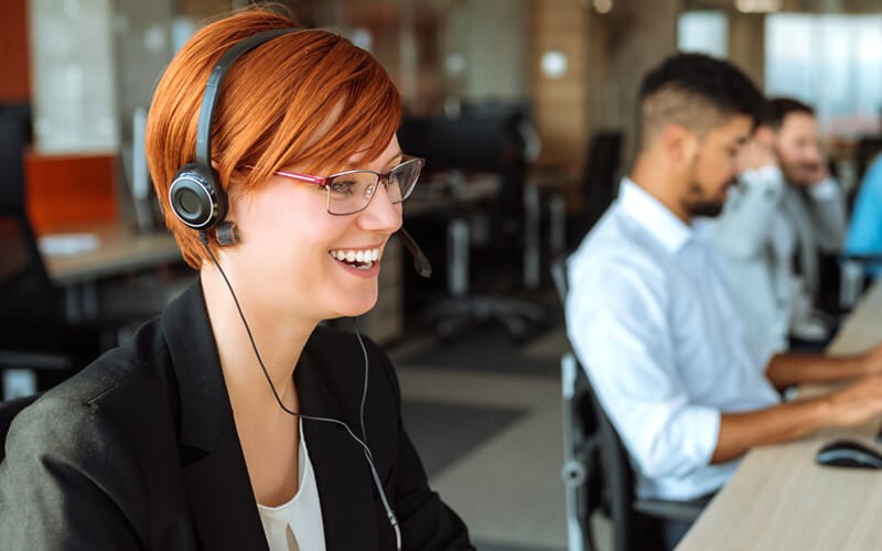 Smiling woman on headset device